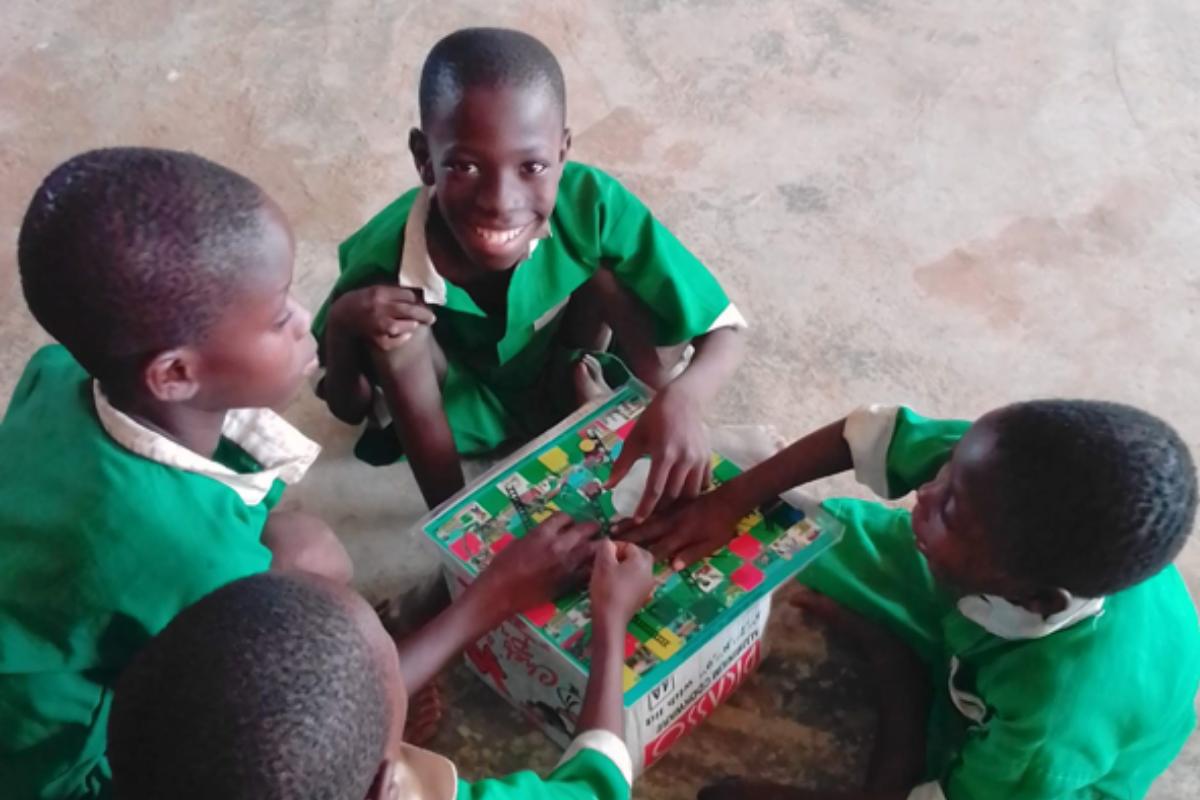 Plate 4: School children playing the Schisto and Ladders™ board game Plate 4: School children playing the Schisto and Ladders™ board game
